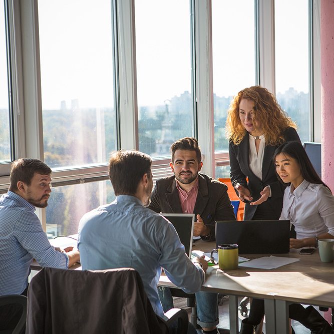 Business team collaborating around a conference table.